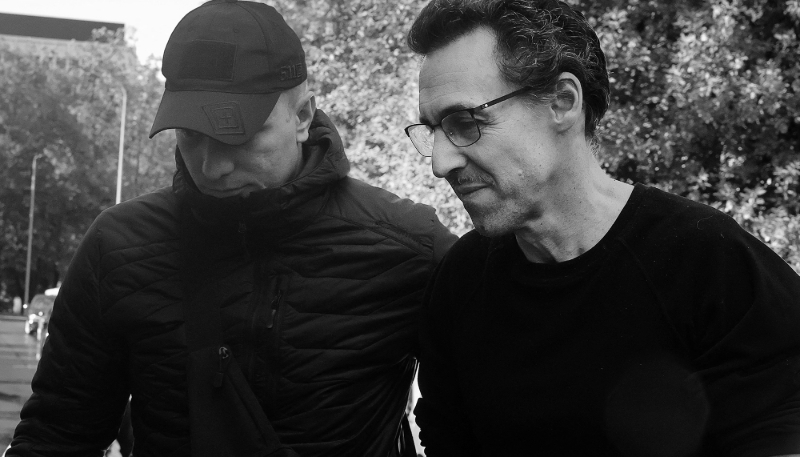 French researcher Laurent Vinatier (R), accused of violating Russia's foreign agent laws, is escorted to a court in Moscow, on 25 August 2025. 