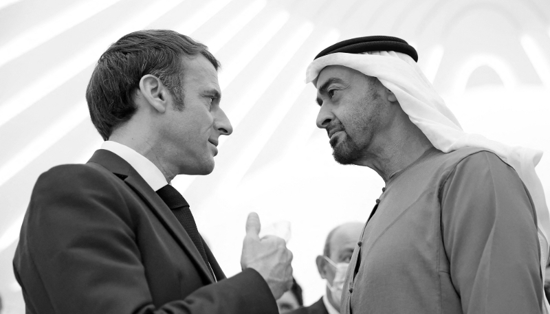 French President Emmanuel Macron is greeted by Abu Dhabi's Crown Prince Mohammed bin Zayed al-Nahyan at the Dubai Expo, on 3 December 2021.