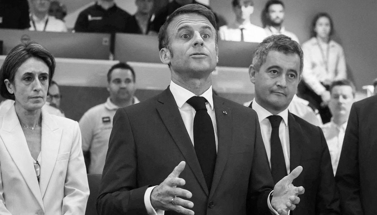 France's President Emmanuel Macron next to Justice Minister Gérald Darmanin in Paris, on 27 July 2024. 