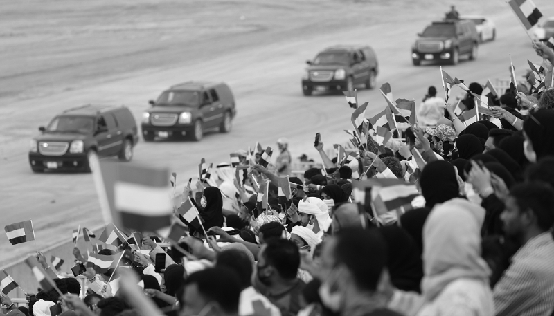 Spectators wave flags at a United Arab Emirates armed forces military exercise at Expo 2020 in Dubai on 5 March 2022.
