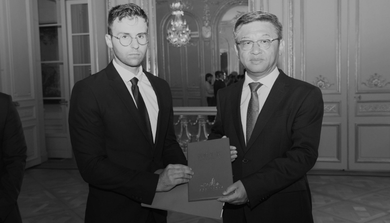 Marcus Détrez (left) and Chen Dong, Minister at the Chinese Embassy in France, attend the ceremony to present the photo album documenting the suffering of Chinese civilians during the Sino-Japanese War, at the Chinese Embassy in France, on 4 August 2025 in Paris. 