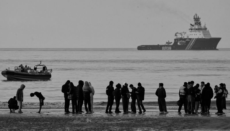 People stand on Gravelines beach, France, a popular departure point for small boats crossing to the United Kingdom, on 6 November 2025. A bilateral agreement was signed in July 2025 between the two countries concerning illegal immigration.